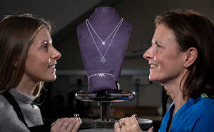 Clare McNaught, RCSEd’s Honorary Secretary launching new range with Hamilton and Inches. Clare is looking at a double chain necklace, with stars and a double chain bracelet with a half sun design. 