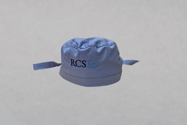 Blue surgical cap with RCSEd logo on the front