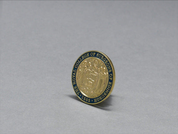 Gold pin badge